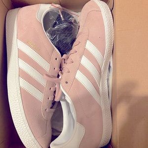 A brand new pair of pink adidas never worn.